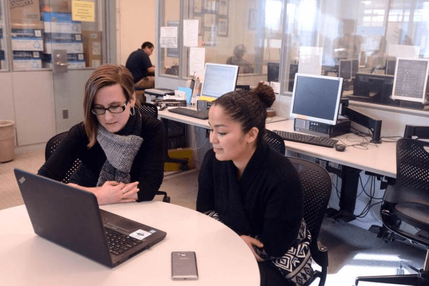 Education Assistant Kathryn Warrender, left, works with Aliana Williams-Gaines of Norwich in the Writing Lab at Three Rivers Community College Tutoring Center.