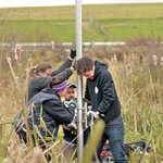 4 people work on retrieving coring samples